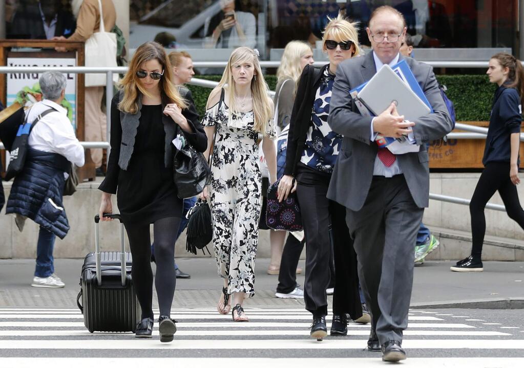 Connie Yates, center, mother of critically ill baby Charlie Gard arrives at the Royal Court of Justice in London, Tuesday, July 25, 2017. Lawyers for the family of critically ill infant Charlie Gard and the hospital treating him were returning to court for a hearing Tuesday, a day after the baby's parents said they were dropping their long legal battle to get him experimental treatment.The subject of Tuesday's hearing at the High Court in London was not immediately clear. (AP Photo/Frank Augstein)