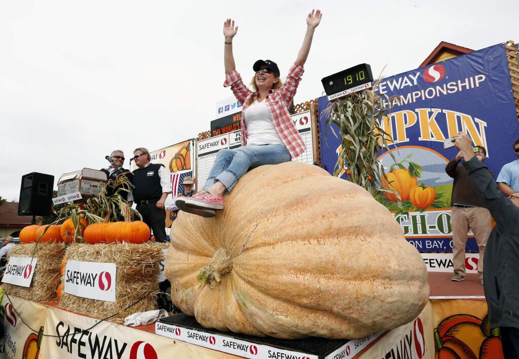 Cindy Tobeck sits atop her pumpkin after winning the Safeway World Championship Pumpkin Weigh-Off at Half Moon Bay, Calif., on Monday, Oct. 10, 2016. Tobeck, of Olympia, Wash., won the contest with the pumpkin that weighed in at 1,910 pounds. (Gary Reyes/BaySan Jose Mercury News via AP)