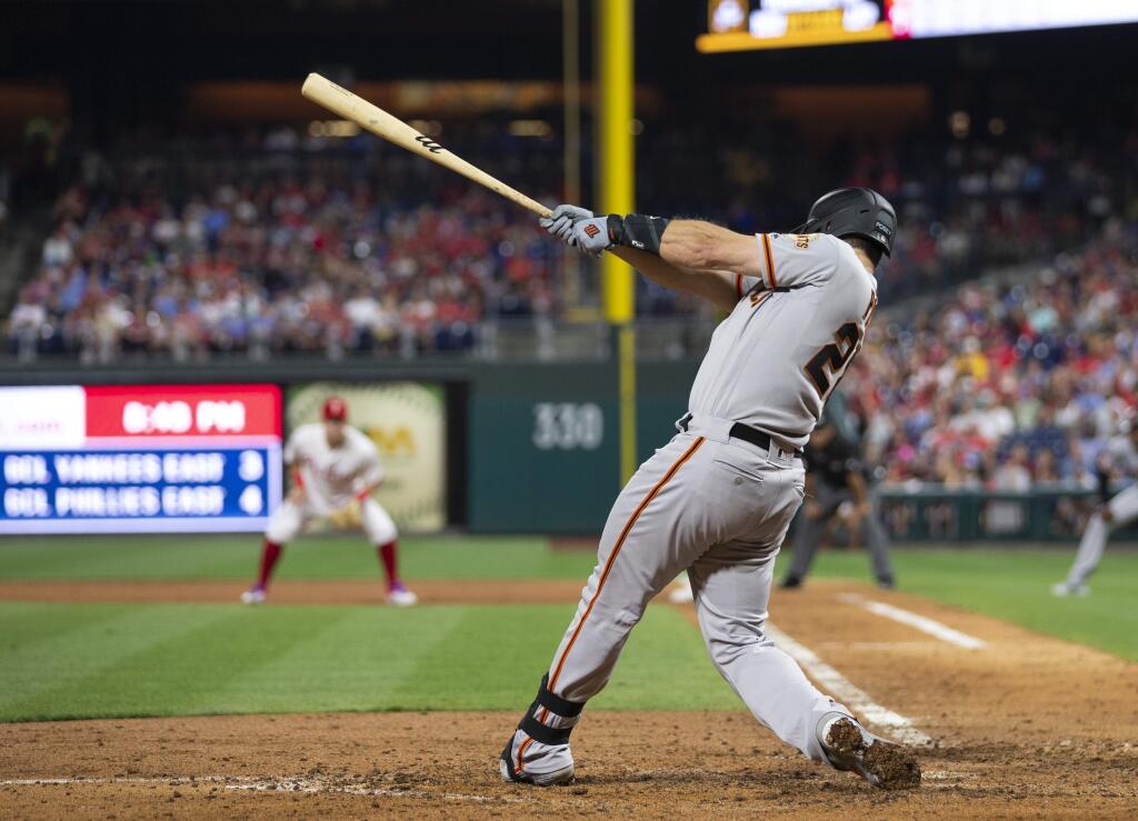 The San Francisco Giants' Buster Posey hits a two-run home run during the sixth inning against the Philadelphia Phillies Wednesday, July 31, 2019, in Philadelphia. (AP Photo/Chris Szagola)