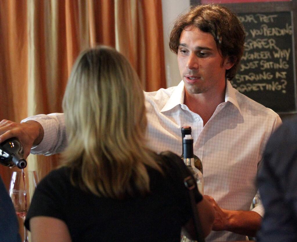 Ben Flajnik, right, of Envolve Winery and also known for his 2012 appearance on 'The Bachelor,' pours his wines for Laura Martensen of Huntington Beach at Valley Wine Shack in Sonoma. (PD File)