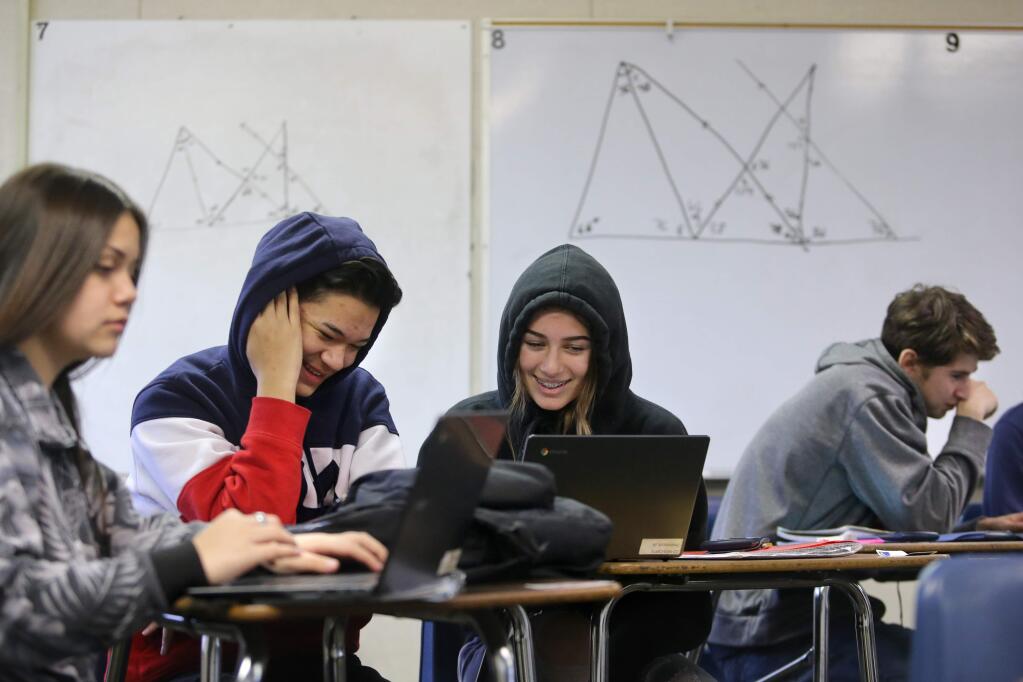 (From left) Victoria Cruz, 14, Matthew Coronado, 14, and Gianna Niemi, 14, learn about diagonals in geometry during a Math 1 class at Montgomery High School in Santa Rosa on Wednesday, February 20, 2019. (BETH SCHLANKER/ The Press Democrat)