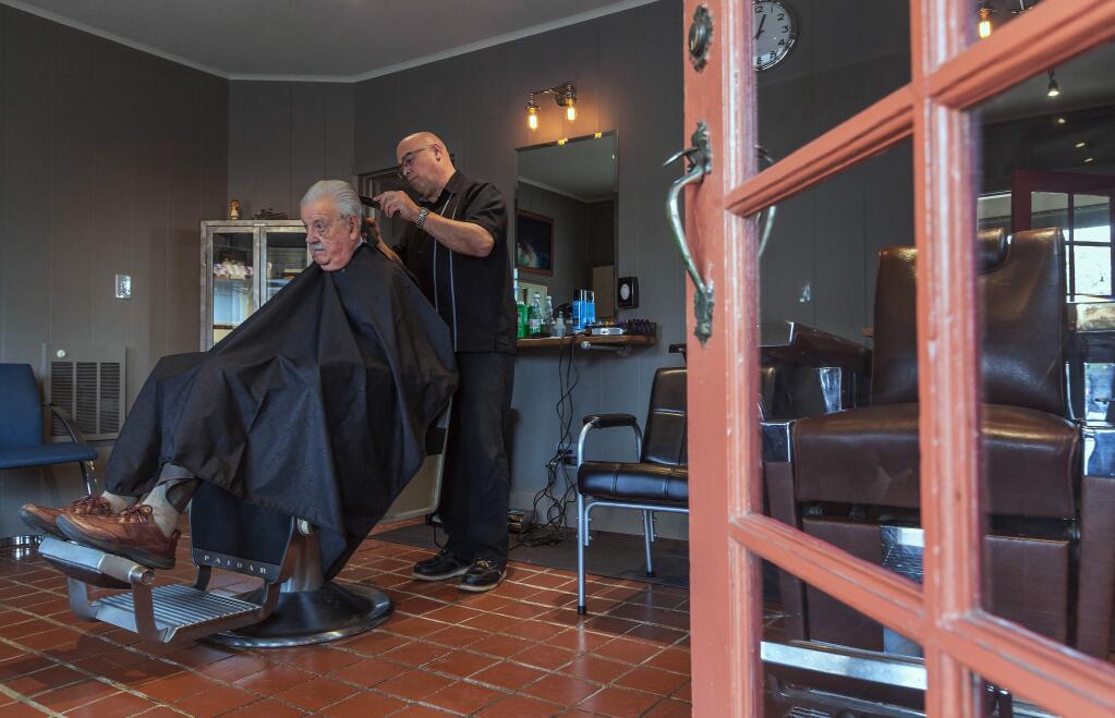 Robbi Pengelly/Index-TribuneAntonio Juan, the new proprietor of the storefront barbershop on Highway 12 where Johnny Mazza cut hair for 60 years, celebrated his opening by giving Johnny a haircut. Following a brief closure for redecorating, the Boyes Hot Springs Barber Shop opened for business on March 15.