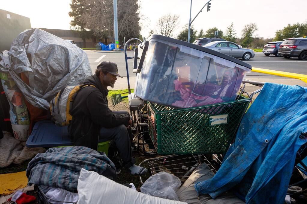 A homeless man known as Snoop sits among his belongings beside Stony Point Road near Joe Rodota Trail, after being forced by authorities to vacate the trail, in Santa Rosa, California, on Saturday, Feb. 1, 2020. (ALVIN JORNADA/ PD)