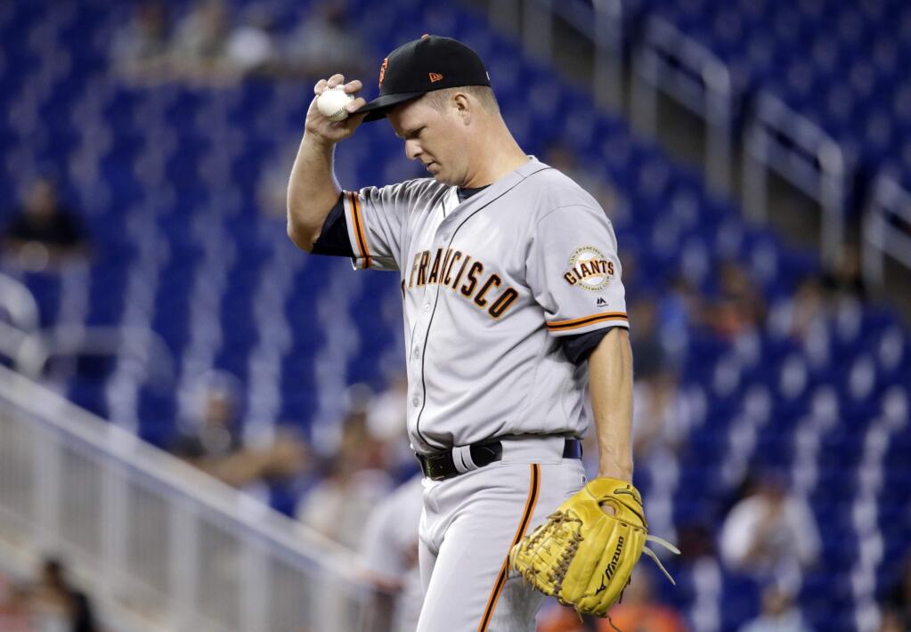 San Francisco Giants starting pitcher Matt Cain pauses while pitching during the first inning against the Miami Marlins, Wednesday, Aug. 16, 2017, in Miami. (AP Photo/Lynne Sladky)