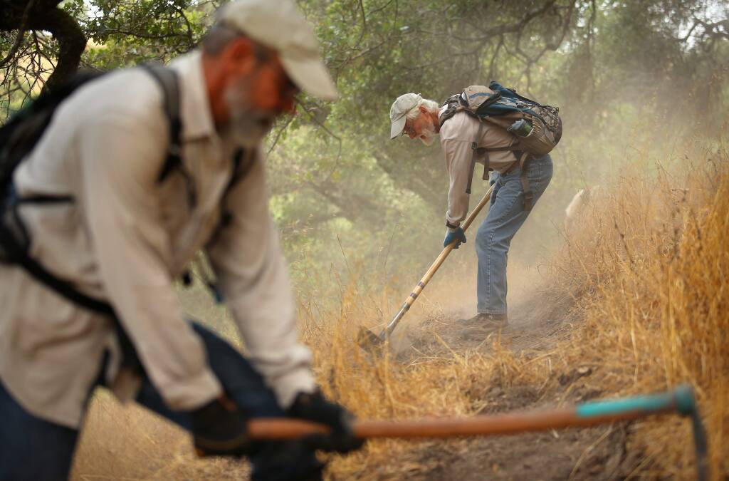 (FILE PHOTO) Tim Mayer, right, and Michael Yares work on cutting a new trail at Taylor Mountain, in Santa Rosa on Wednesday, August 6, 2014. (Christopher Chung/ The Press Democrat)