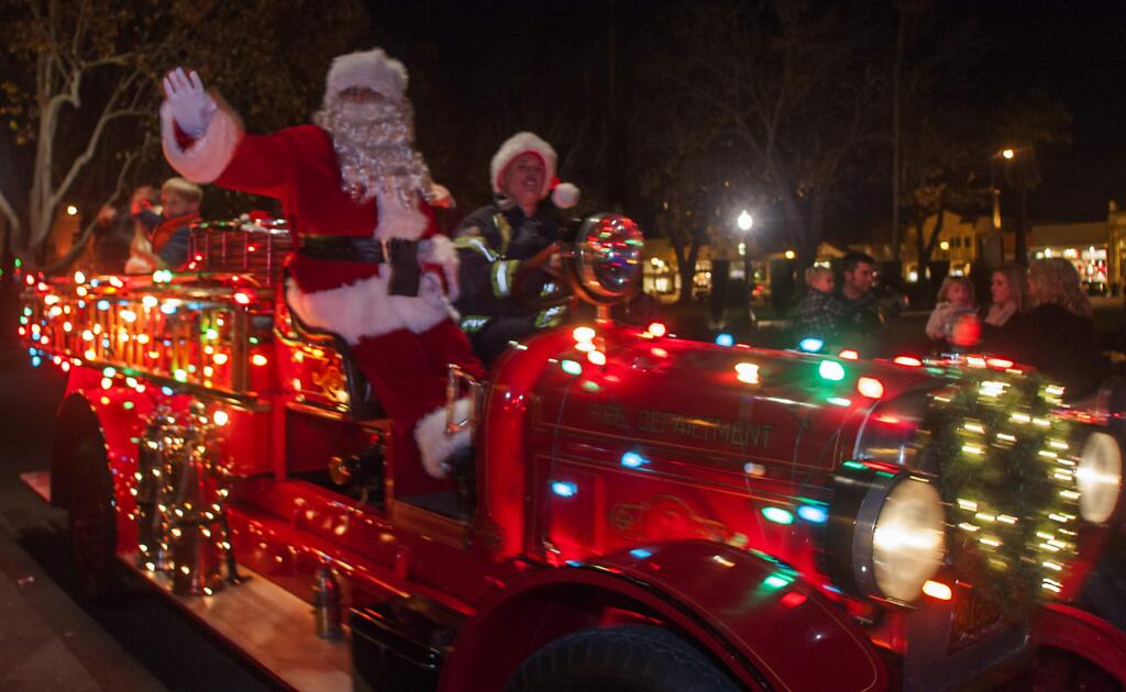 Santa, shown here whizzing by the Plaza in 2012, will be spreading good cheer once again this Friday.