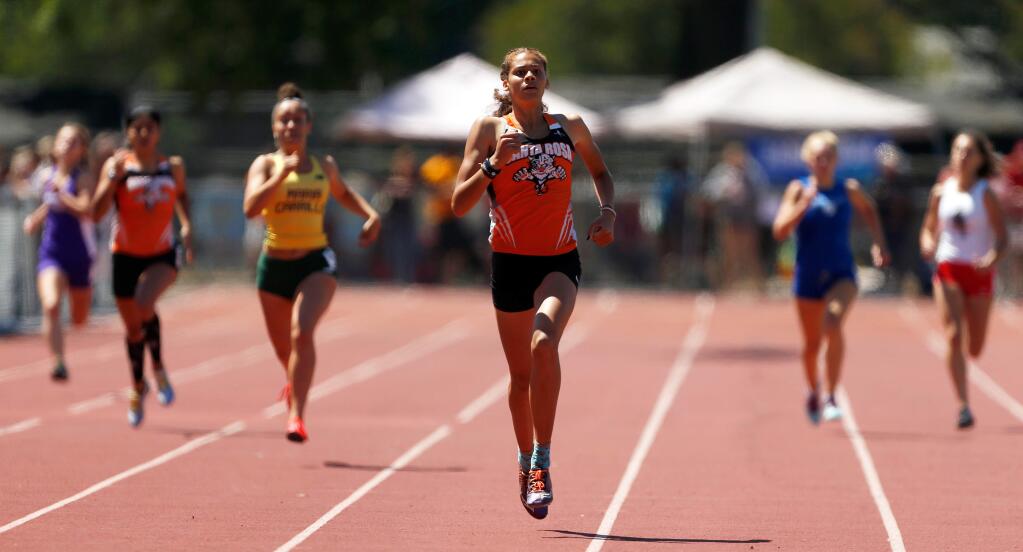 Santa Rosa's Kirsten Carter holds a commanding lead in the girls' 400-meter dash during the Redwood Empire track and field championships at Santa Rosa High School on Saturday, May 19, 2018. (Alvin Jornada / The Press Democrat)
