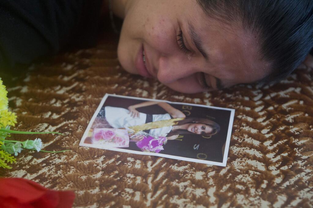 Keyling Enamorado, a friend of slain beauty queen Maria Jose Alvarado, cries on Maria's coffin in Santa Barbara, Honduras, Thursday, Nov. 20, 2014. Grieving family members laid to rest the Honduran beauty queen and her sister, Sofia, after the women were shot to death in what police say was a jealous rage by the sister's boyfriend. (AP Photo/Esteban Felix)