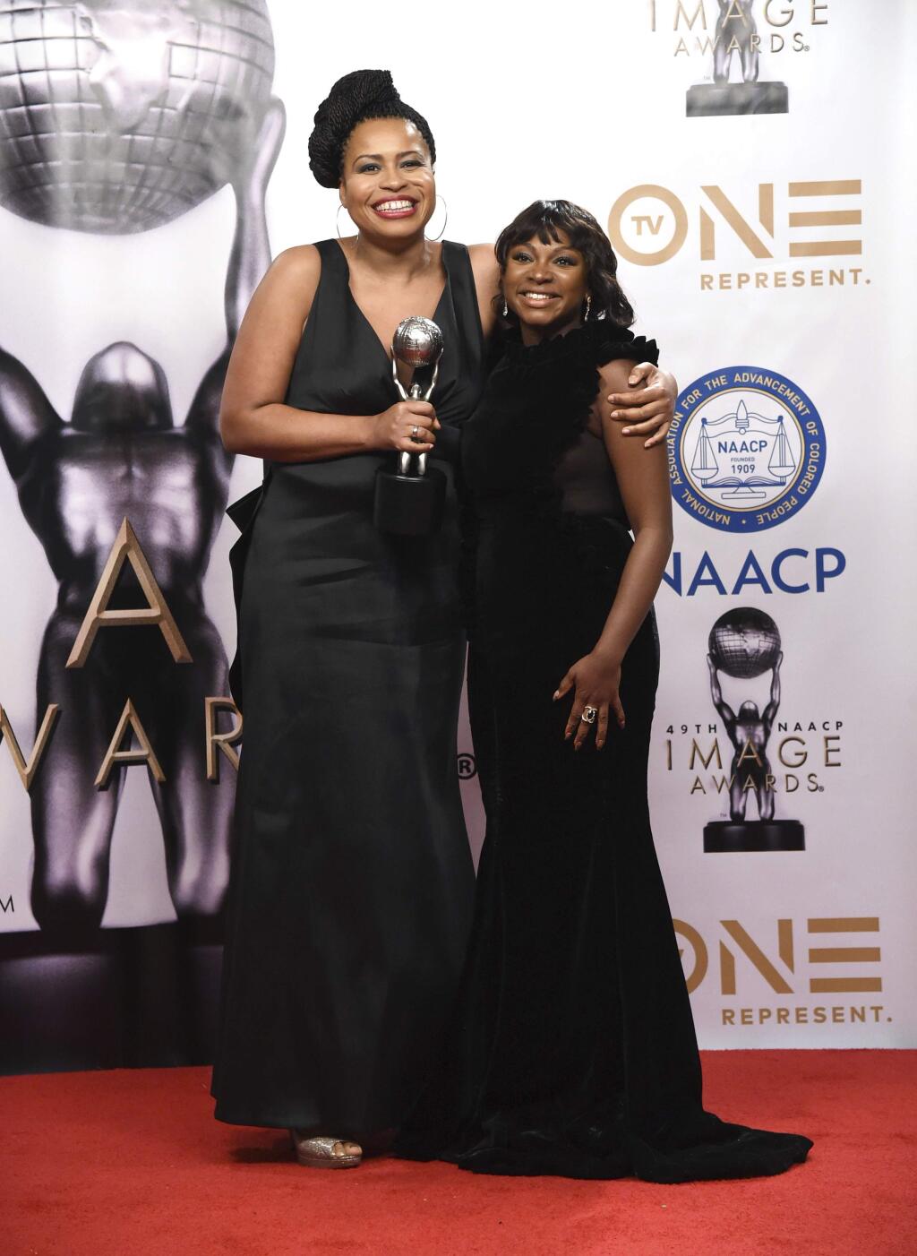 Courtney Kemp Agboh, left, and Naturi Naughton pose in the press room with the award for outstanding drama series for 'Power' at the 49th annual NAACP Image Awards at the Pasadena Civic Auditorium on Monday, Jan. 15, 2018, in Pasadena, Calif. (Photo by Richard Shotwell/Invision/AP)