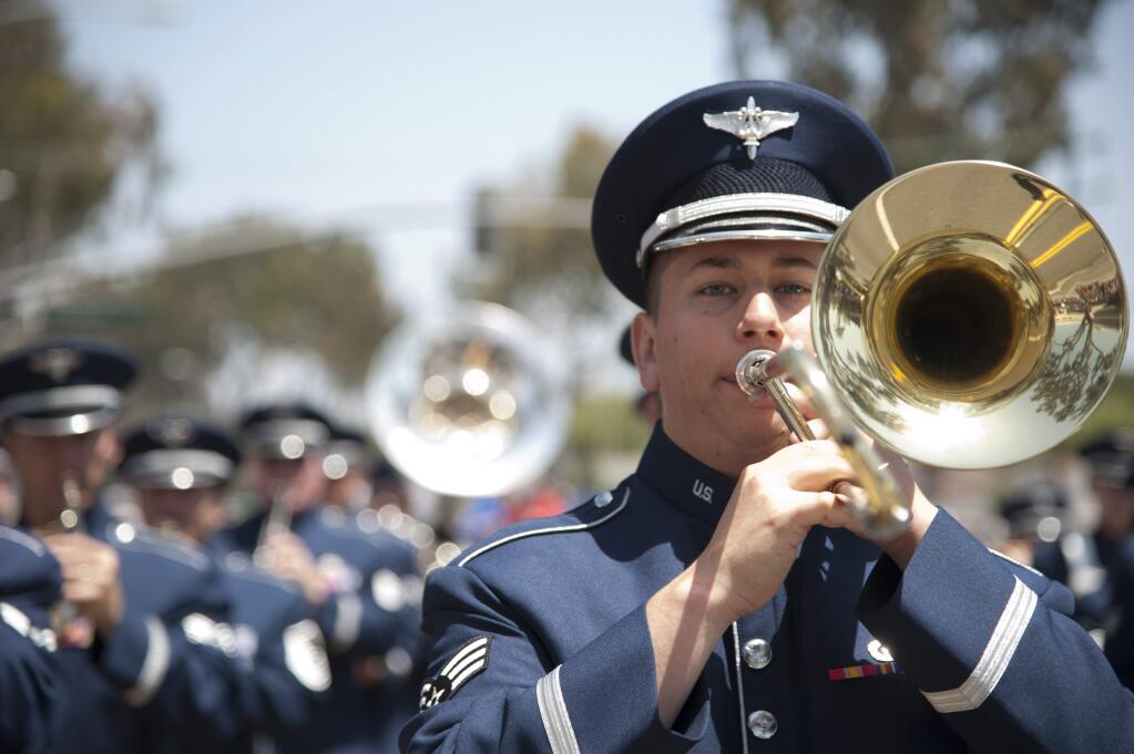 Senior Airman Ryan Terronez, USAF Band of the Golden West trombone player, marches with the band during the Armed Forces Day parade.