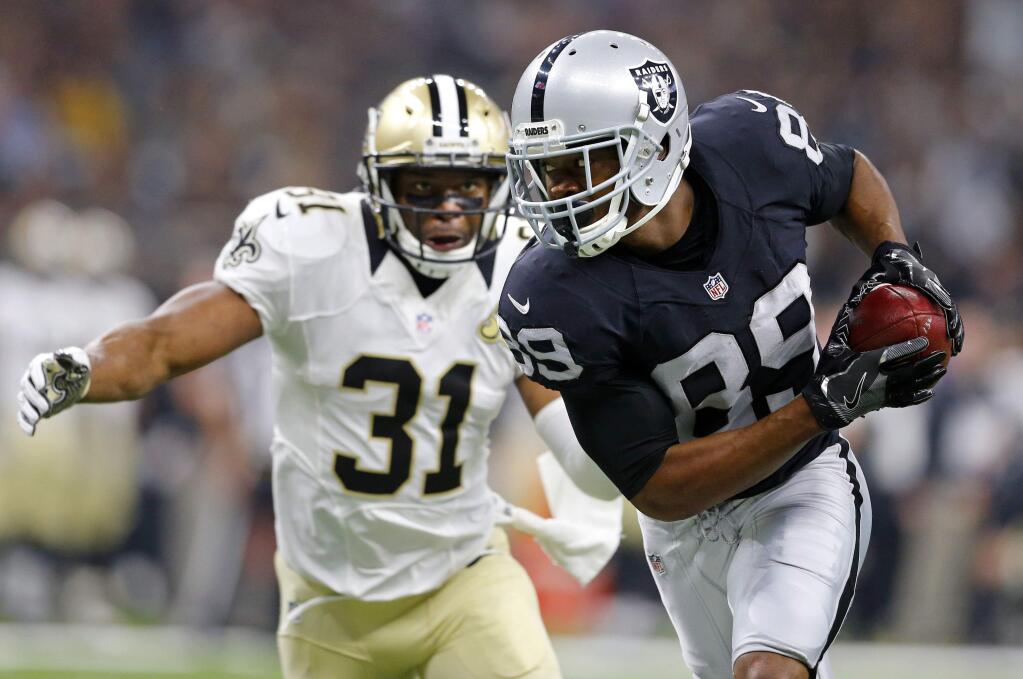 In this Sunday, Sept. 11, 2016, file photo, Oakland Raiders wide receiver Amari Cooper (89) pulls in a pass reception in front of New Orleans Saints free safety Jairus Byrd (31) in the first half of a game in New Orleans. (AP Photo/Butch Dill, File)