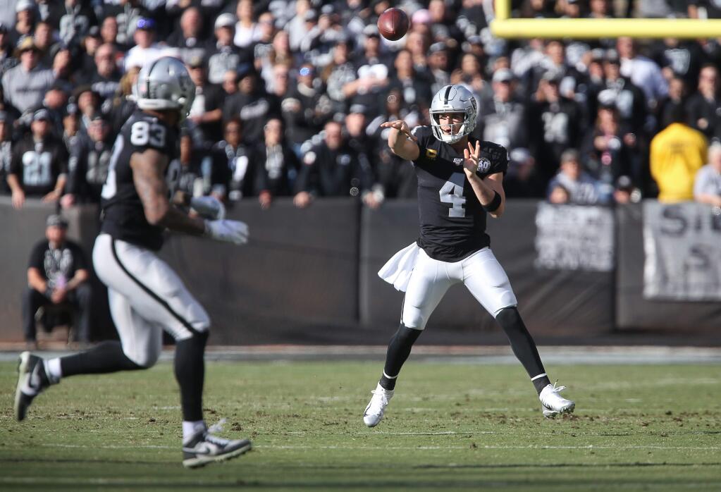Oakland Raiders quarterback Derek Carr delivers a pass to Oakland Raiders tight end Darren Waller during their game against the Jacksonville Jaguars in Oakland on Sunday, December 15, 2019. (Christopher Chung/ The Press Democrat)