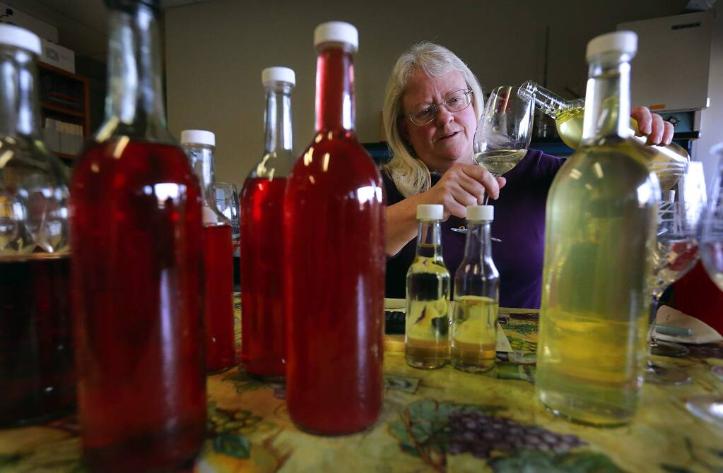 Carol Shelton tries samples of the 2014 Wild Thing Chardonnay, right, and the 2014 Wild Thing Dry Rose of Carignane at her Santa Rosa winery. Shelton was making the final tweaks to the blends before bottling next week. (Photo by John Burgess/The Press Democrat)