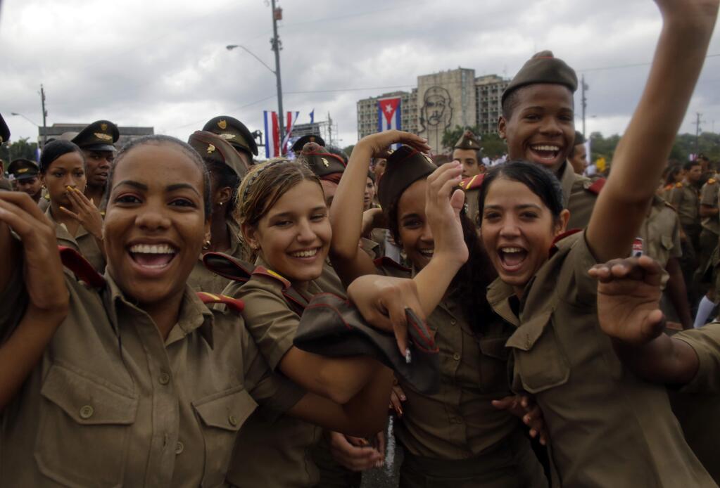 Cuban army cadets react to the photographer as they march in Revolution Square marking May Day, in Havana, Cuba, Friday, May 1, 2015. Thousands of people converged on the plaza for the traditional march, led this year by President Raul Castro and Venezuelan President Nicolas Maduro. (AP Photo/Ramon Espinosa)