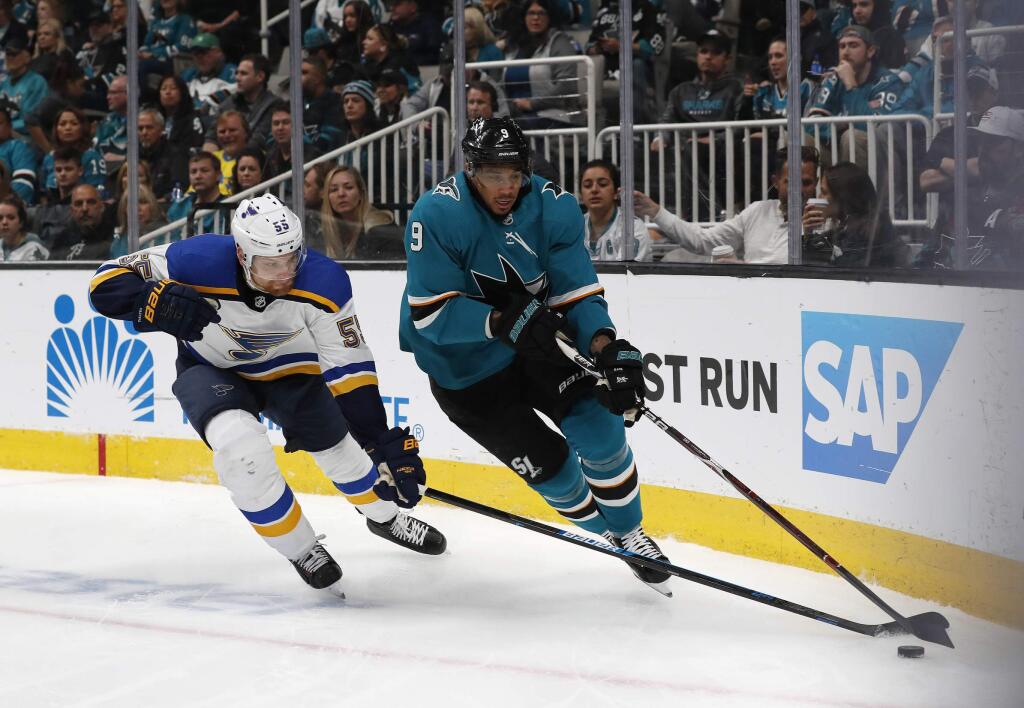 St. Louis Blues' Colton Parayko (55) battles for the puck against San Jose Sharks' Evander Kane (9) in the first period in Game 5 of the NHL hockey Stanley Cup Western Conference finals in San Jose, Calif., on Sunday, May 19, 2019. (AP Photo/Josie Lepe)