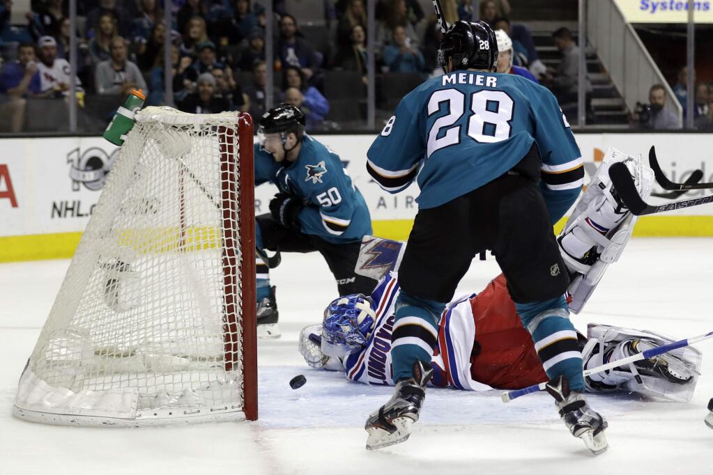 New York Rangers goalie Henrik Lundqvist, center, is beaten for a goal on a shot from San Jose Sharks center Chris Tierney (50) during the second period of an NHL hockey game Tuesday, March 28, 2017, in San Jose, Calif. (AP Photo/Marcio Jose Sanchez)