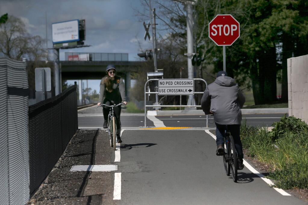 Emily Townshend rides her bike at the start of a section of the SMART pathway near Golf Course Dr. in Rohnert Park, California on Thursday, March 21, 2019 .(BETH SCHLANKER/The Press Democrat)