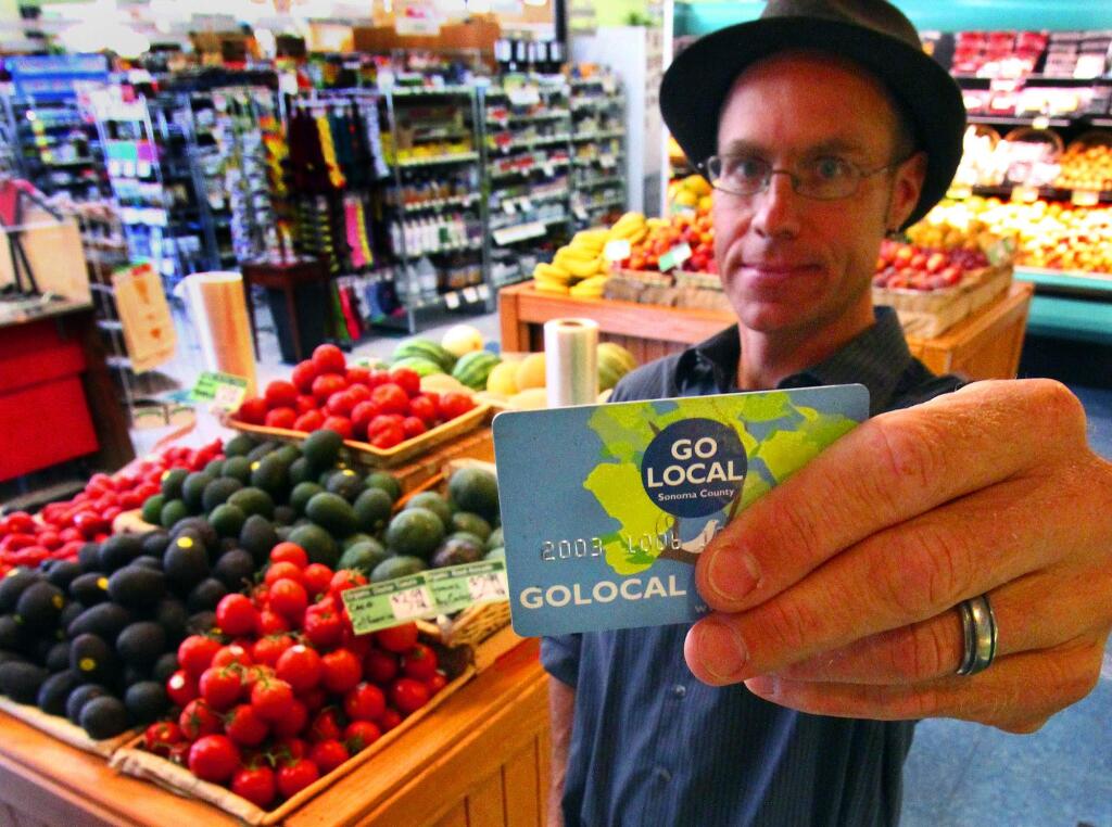 8/19/2012: E1:PC: BC Capps has had his Go Local card almost since it was started; he is in the produce section of the Community Market. August 16, 2012.
