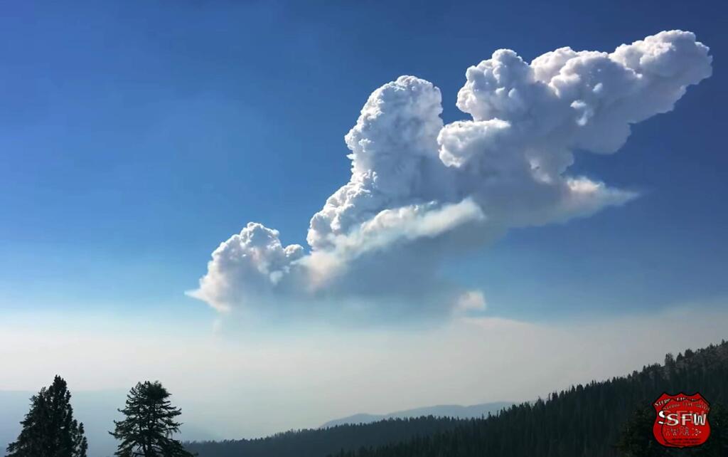 This Sunday, July 15, 2018 image from video provided by Sierra Fire Watch shows a large fire and smoke plume rising over an area northwest of Yosemite National Park as the Ferguson fire continues to spread in California's Sierra Nevada.The U.S. Forest Service said Wednesday morning, July 18, 2018 the blaze is 27 square miles (70 square kilometers) and is just 5 percent contained. More than 1,800 firefighters are battling the blaze in Mariposa County that started Friday, July 13. (Sierra Fire Watch via AP)