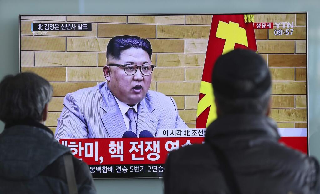South Koreans watch a TV news program showing North Korean leader Kim Jong Un's New Year's address, at the Seoul Railway Station in Seoul, South Korea, Monday, Jan. 1, 2018. The part of letters on the bottom 'South Korea and U.S., Nuclear War exercise.' and on top left, 'Kim Jong Un delivers New Year's address.' North Korean leader Kim Jong Un said Monday, Jan. 1, 2018, the United States should be aware that his country's nuclear forces are now a reality, not a threat. But he also struck a conciliatory tone in his New Year's address, wishing success for the Winter Olympics set to begin in the South in February and suggesting the North may send a delegation to participate.(AP Photo/Lee Jin-man)