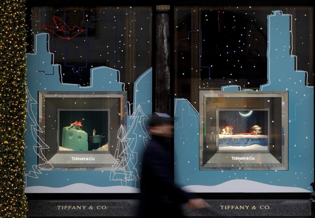 A pedestrian passes the shop window of Tiffany & Co. in London, Monday, Nov. 25, 2019. French luxury group LVMH has agreed to buy iconic New York jeweler Tiffany & Co. for $16.2 billion, adding a famed star to its portfolio that already boasts Louis Vuitton, Christian Dior and Bulgari. (AP Photo/Kirsty Wigglesworth)
