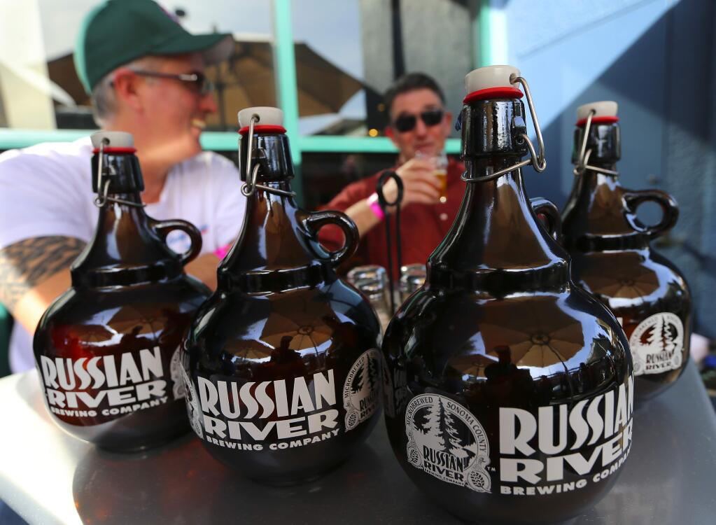 Michael Cole, lett, and Jim O'Connell brought their growlers at the Pliny the Younger release day at Russian River Brewing Company in Santa Rosa on Friday. (JOHN BURGESS / The Press Democrat)