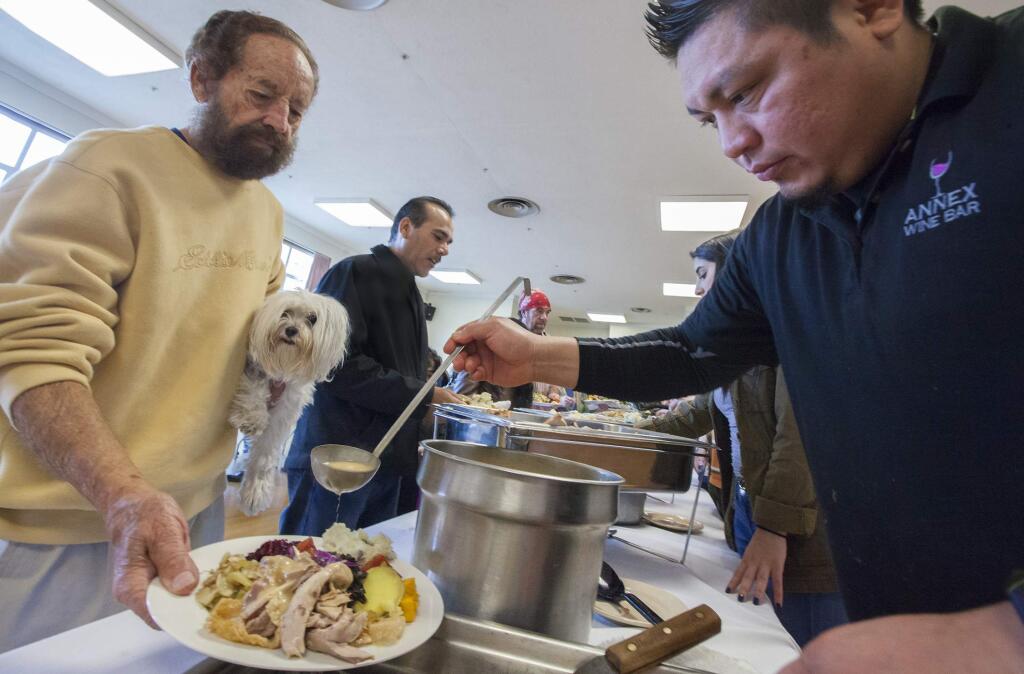 Wayne Lazarus with Karmia was one of the hundreds who enjoyed a traditional holiday dinner in 2016. The Sonoma Community Center willagain this year host its annual free Thanksgiving Day Dinner at the Sonoma Valley Veterans Memorial Hall. (Photo by Robbi Pengelly/Index-Tribune)