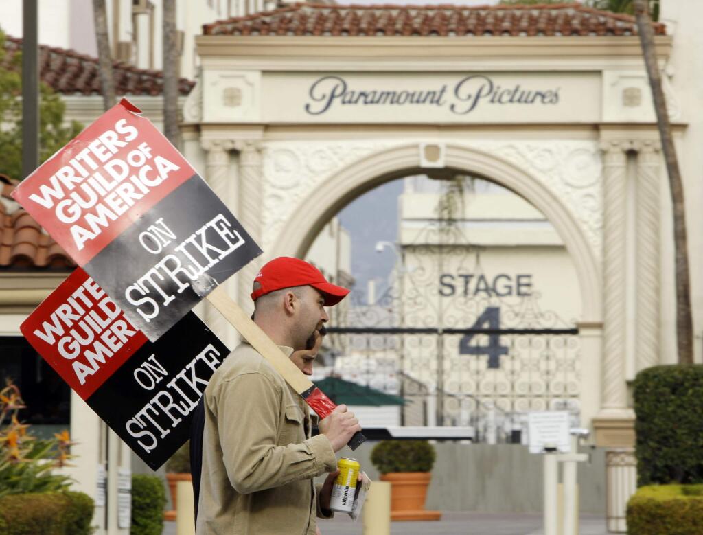 FILE - In this Jan. 23, 2008 file photo, striking film and television writers picket outside Paramount Studios in Los Angeles. (AP Photo/Kevork Djansezian, File)