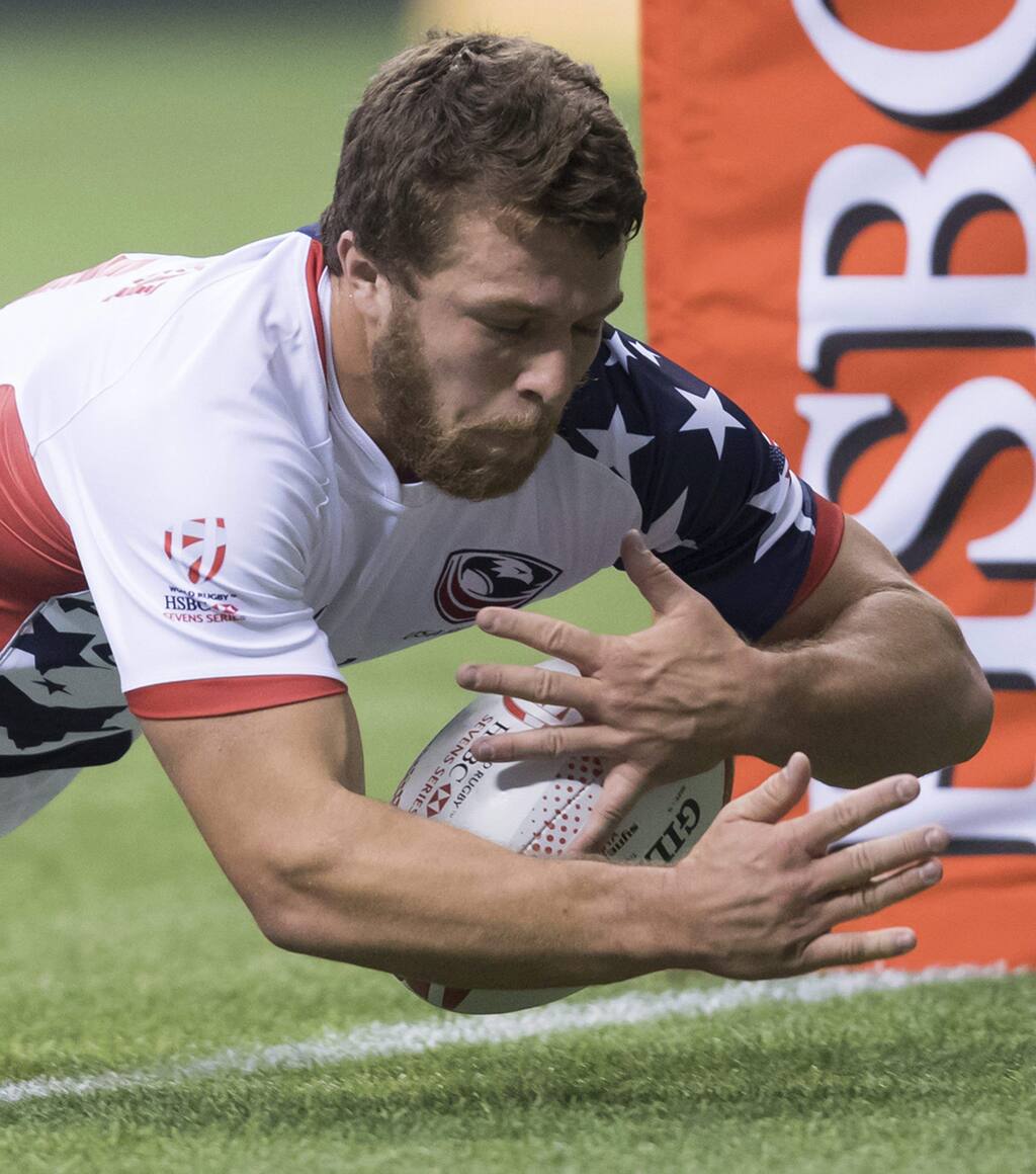 The United States' Stephen Tomasin, a Cardinal Newman grad, scores a try against Japan during a World Rugby Sevens Series match in Vancouver on Saturday, March 11, 2017. (Darryl Dyck/The Canadian Press via AP)