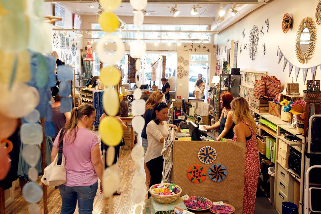 (FILE PHOTO) Customers browse and purchase products at One World Fair Trade in Healdsburg, California on Wednesday, July 26, 2017. (Alvin Jornada / The Press Democrat)
