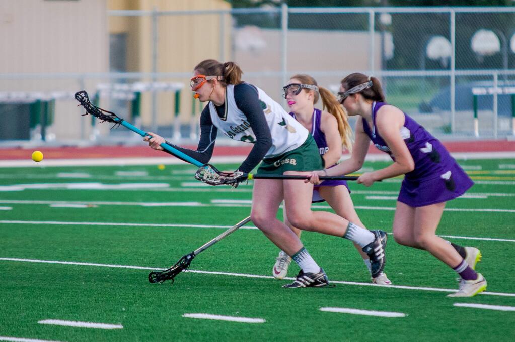 GREG GARDEA/FOR THE ARGUS-COURIERCasa Grande's Mia Cain heads downfield pursued by Petaluma defenders in a match won by Petaluma, 10-8. Casa's lacrosse program has grown to include both a varsity and junior varsity team