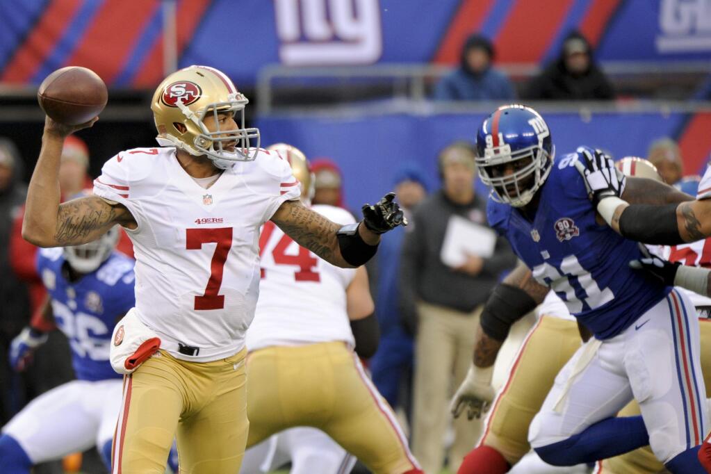 San Francisco 49ers quarterback Colin Kaepernick (7) throws a pass during the second half of an NFL football game against the New York Giants Sunday, Nov. 16, 2014, in East Rutherford, N.J. (AP Photo/Bill Kostroun)