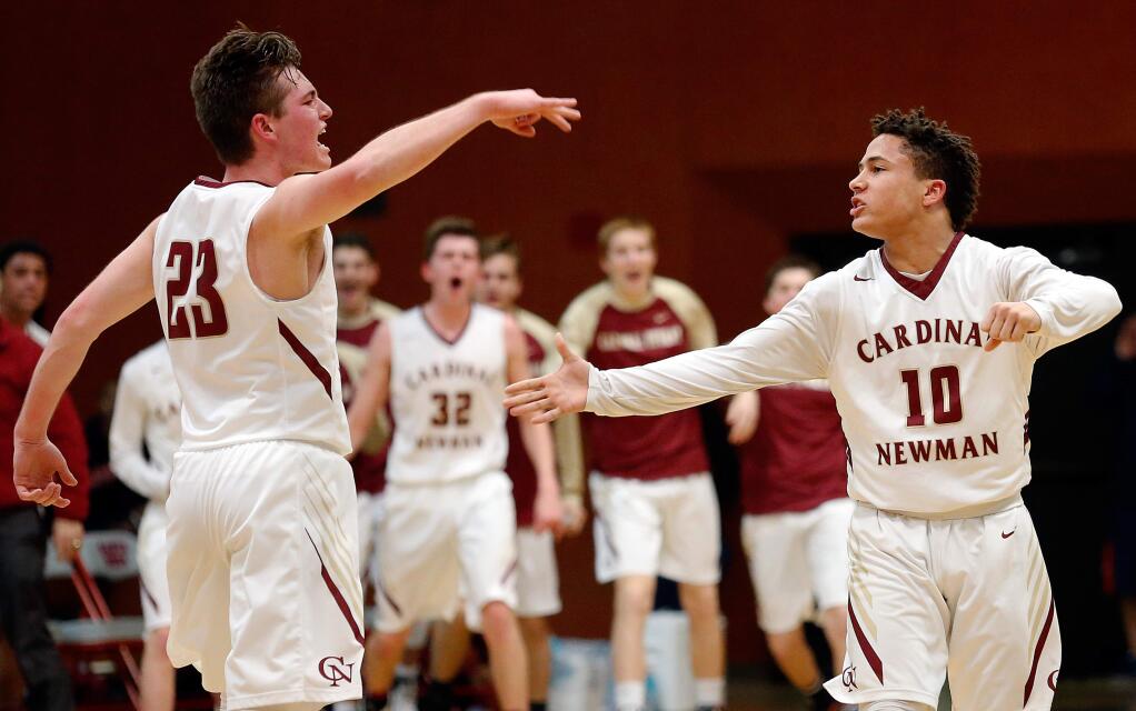 Cardinal Newman's Brad Morato, left, celebrates with Damian Wallace after Morato scored a three-pointer assisted by Wallace during the first half of the North Bay League tournament championship game on Friday, February 17, 2017. (Alvin Jornada / The Press Democrat)
