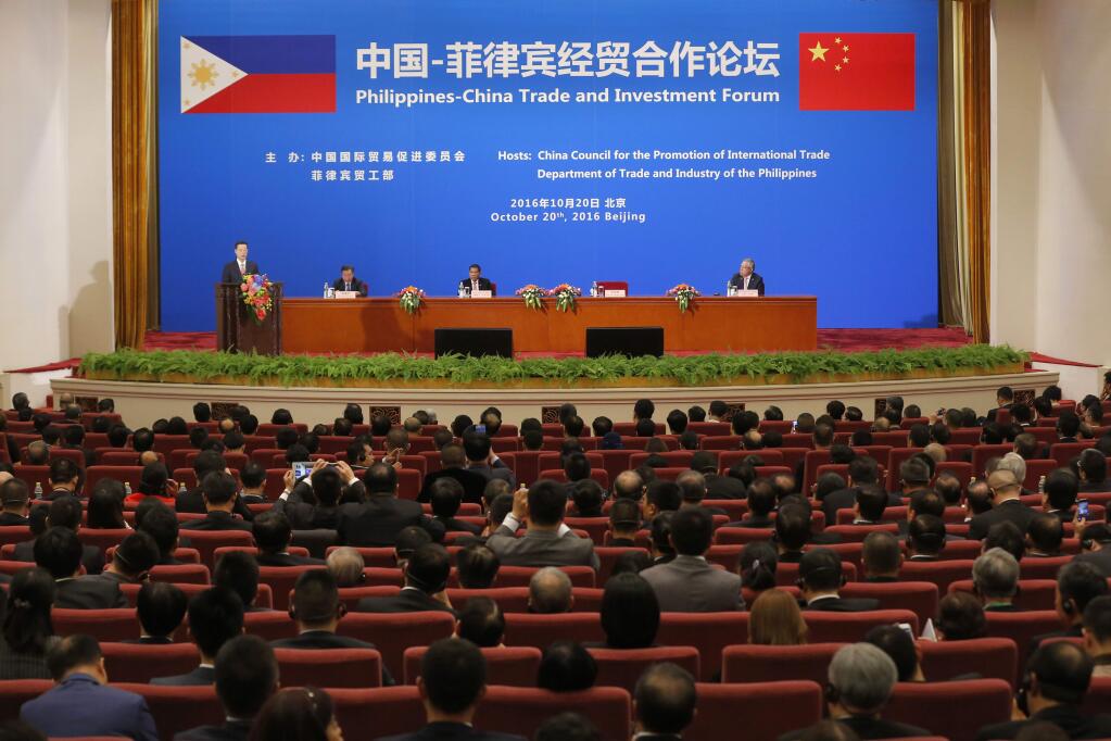 Chinese Vice-Premier Zhang Gaoli, left, speaks as Philippine President Rodrigo Duterte, third from left, listens during the Philippines-China Trade and Investment Forum at the Great Hall of the People in Beijing Thursday, Oct. 20, 2016. China and the Philippines have agreed to resume a dialogue on their dispute over the South China Sea, a senior Chinese diplomat said Thursday following talks between the countries' leaders. (Wu Hong/Pool Photo via AP)