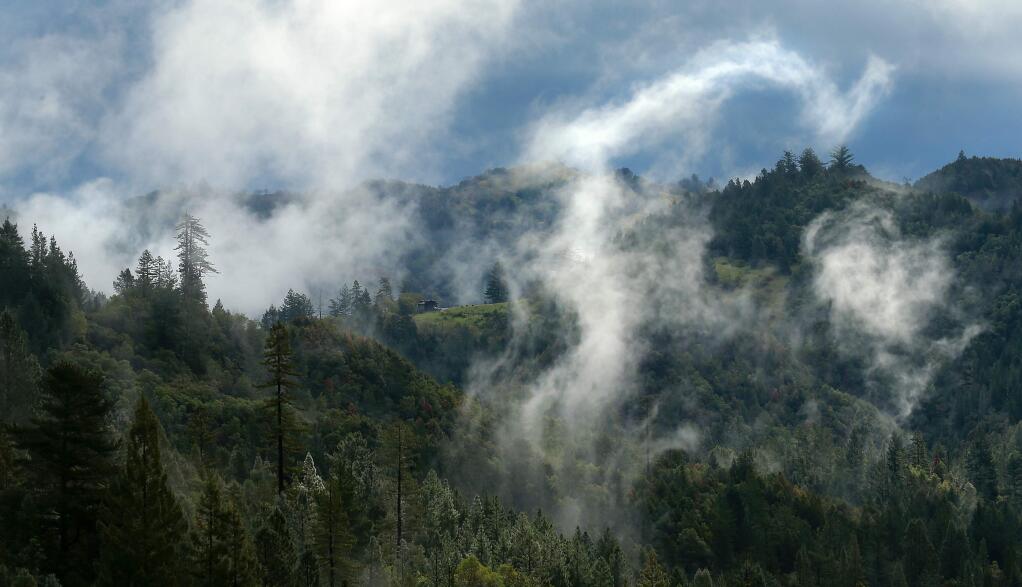 Clouds swirl through the coastal mountains off Ft. Ross Rd. west of Cazadero on Wednesday morning as the sun peeks out to warm up the Sonoma landscape. (John Burgess/The Press Democrat)
