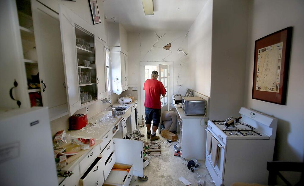 Virtually untouched for a year, Brian Jones of Brian Jones Construction of Napa inspects a home that he is repairing Wedenesday Aug.19, 2015 damaged in last years 6.0 Napa earthquake. (Kent Porter / Press Democrat) 2015