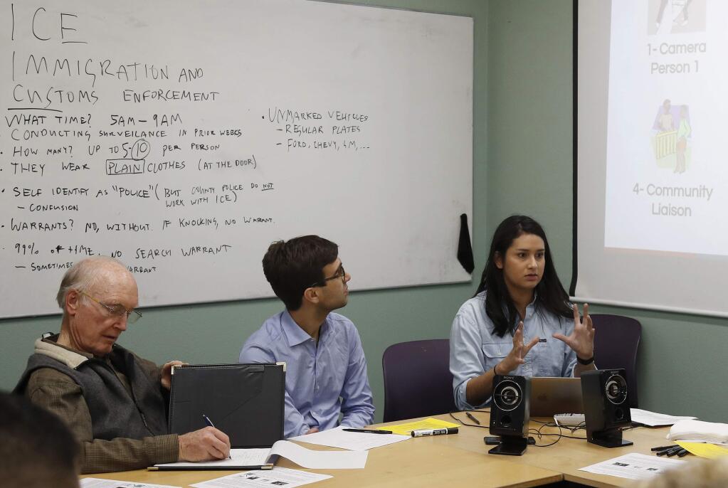 In this Feb. 1, 2018 photo, Mariela Garcia, right, community organizer at Sacred Heart Community Service, leads a 'Rapid Response Training' class on how to respond to ICE raids at Sacred Heart Community Service in San Jose, Calif. Immigrant rights groups are organizing a new network of neighborhood watch teams in California and elsewhere in response to threats by the Trump Administration of a deepening crackdown against those living in the country illegally. (Nhat V. Meyer/San Jose Mercury News via AP)