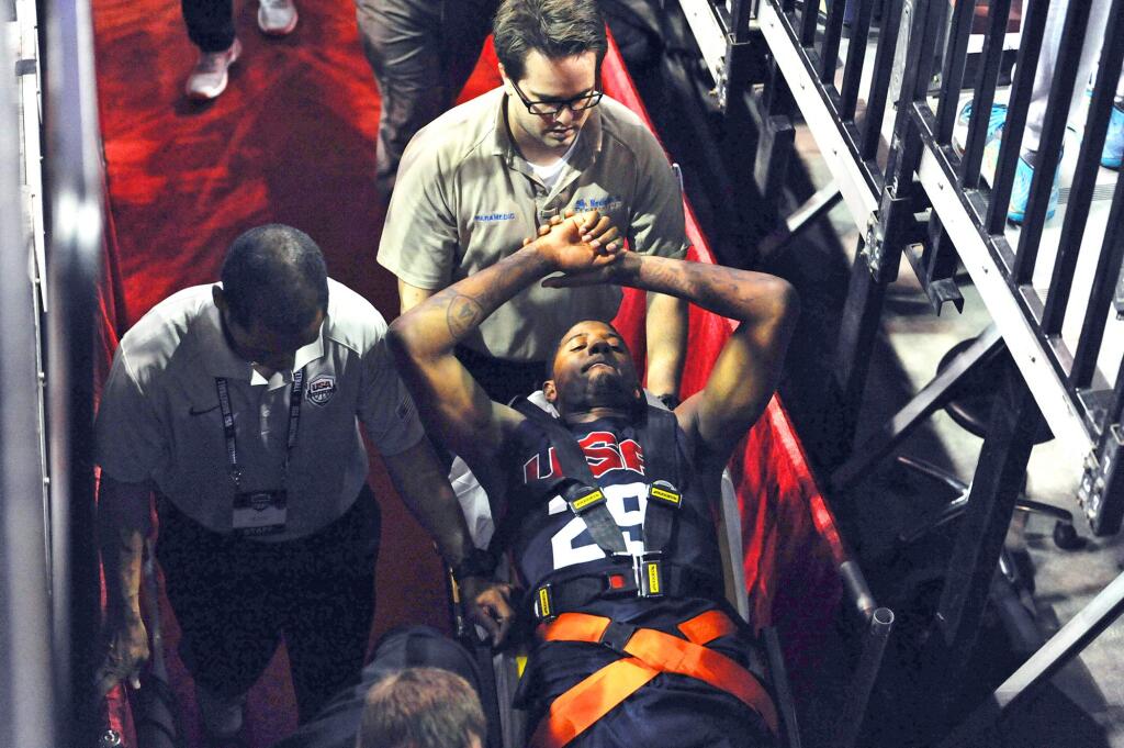 In this photo provided by the Las Vegas News Bureau, Indiana Pacers' Paul George is carted off the court after breaking his right leg during the USA Basketball Showcase intrasquad game in Las Vegas on Friday, Aug. 1, 2014. (AP Photo/Las Vegas News Bureau, Glenn Pinkerton)