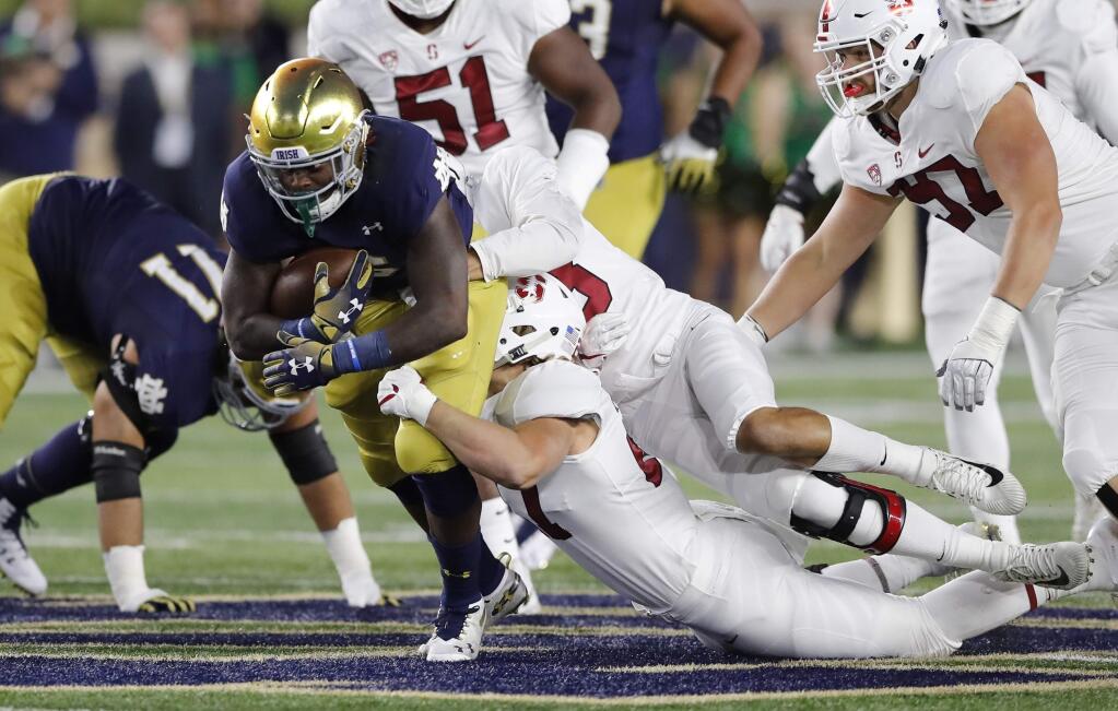 Notre Dame running back Tony Jones Jr. is stopped by the Stanford defense during the first half of an NCAA college football game Saturday, Sept. 29, 2018, in South Bend, Ind. (AP Photo/Carlos Osorio)