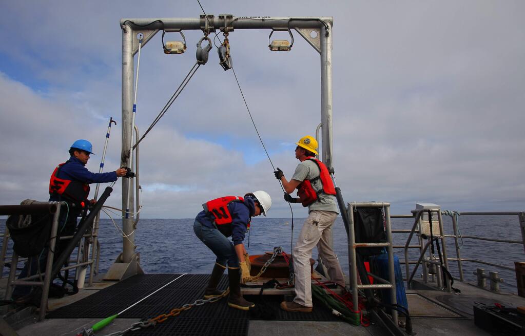 Danielle Lipski, research coordinator with the Cordell Bank National Marine Sanctuary and Dale Hubbard, senior faculty research assistant at Oregon State University, prepare to deploy an anchor attached to an acoustic mooring in the Cordell Bank National Marine Sanctuary, on Thursday, October 15, 2015. (Christopher Chung/ The Press Democrat)