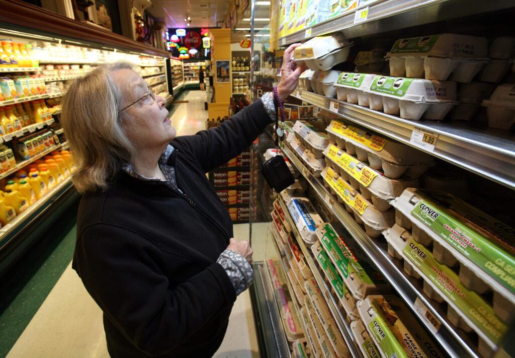 Martha Joyce of Petaluma buys eggs at Petaluma Market on Tuesday, January 20, 2015. (SCOTT MANCHESTER/ARGUS-COURIER STAFF)