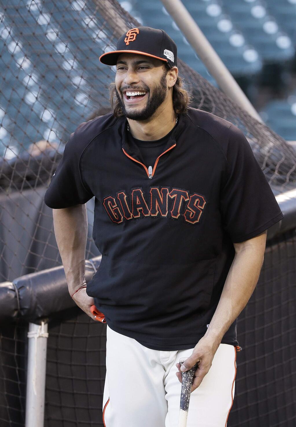 San Francisco Giants' Michael Morse laughs while standing behind the batting cage during the Giants' workout Thursday, Oct. 23, 2014, in San Francisco. The Giants are scheduled to face the Kansas City Royals in the third game of the baseball World Series on Friday. (AP Photo/Eric Risberg)