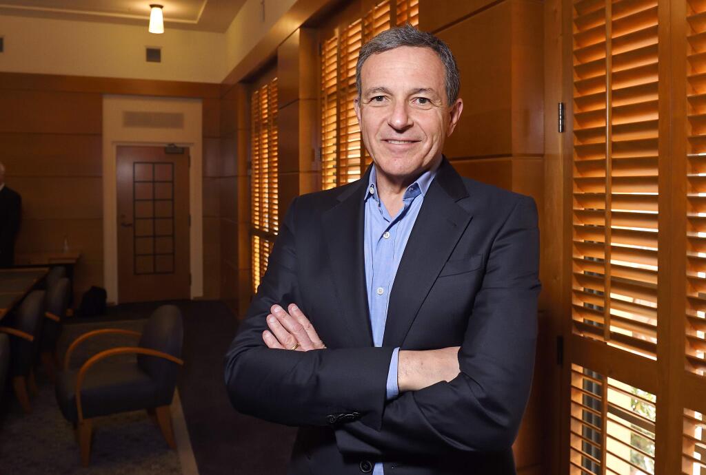FILE - In this Thursday, Dec. 10, 2015, file photo, Bob Iger, chairman and CEO of The Walt Disney Company, poses in a conference room before speaking to members of the media about bringing NFL football back to the Los Angeles area, in Burbank, Calif. On Thursday, March 23, 2017, The Walt Disney Co. announced that Iger is getting a one-year contract extension, to July 2, 2019. (AP Photo/Mark J. Terrill, File)
