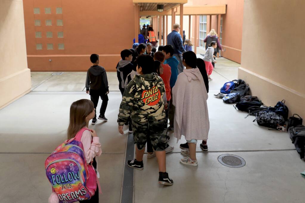 Children line up for a morning recess on Thursday, April 4, 2019 at the Fitch Mountain campus, where third through fifth graders from Healdsburg Elementary and Healdsburg Charter School attend. (Kent Porter / The Press Democrat) 2019