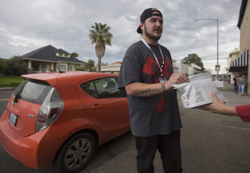 Courier Jacob makes a cannabis delivery on West Napa Street, one of his frequent stops in Sonoma.