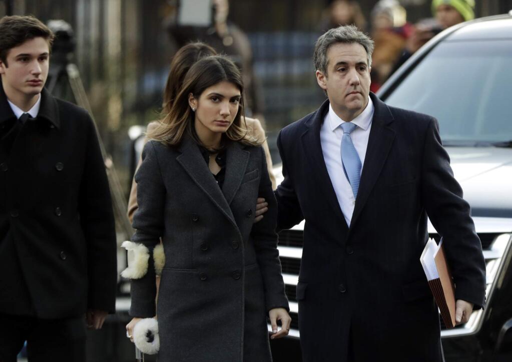 Michael Cohen, right, President Donald Trump's former lawyer, arrives at federal court with his daughter, Samantha Cohen, center, and son, Jake Cohen, for his sentencing for dodging taxes, lying to Congress and violating campaign finance laws in New York on Wednesday, Dec. 12, 2018. (AP Photo/Julio Cortez)