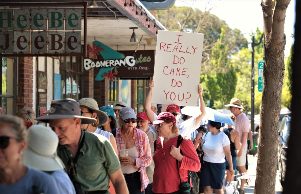 Protesters carrying signs and chanting, march on 4th street in Petaluma in the Families Belong Together March, Saturday June 30th, 2018. (Photo Will Bucquoy / For the Press Democrat).