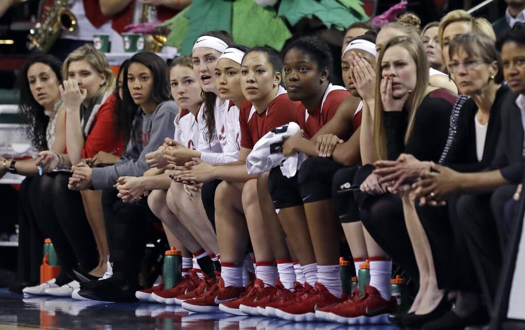 Players and coaches on the Stanford bench look on against Oregon late in the second half in the finals of the Pac-12 Conference women's tournament, Sunday, March 4, 2018, in Seattle. Oregon won 77-57. (AP Photo/Elaine Thompson)