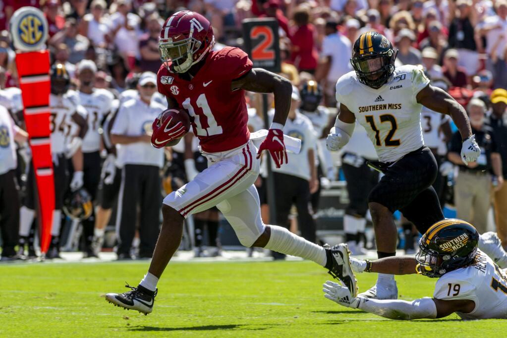 In this Sept. 21, 2019, file photo, Alabama wide receiver Henry Ruggs runs in for a touchdown on a pass reception against Southern Mississippi during the first half in Tuscaloosa, Ala. The Los Angeles Raiders selected Ruggs in the first round of the NFL draft. (AP Photo/Vasha Hunt, File)