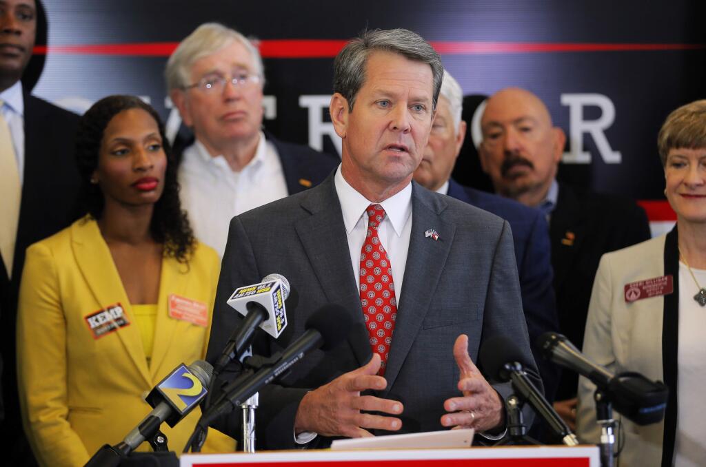 FILE- In this Aug. 29, 2018 file photo, Georgia Secretary of State and GOP gubernatorial candidate Brian Kemp speaks a press conference in Atlanta. The final stretch of the hotly contested Georgia governor's race is being consumed by a bitter political battle over access to the polls. Kemp says that Democratic gubernatorial candidate Stacey Abrams is fighting for immigrants without legal status to cast ballots in the Nov. 6 election. Abrams' campaign says that's untrue and Kemp is trying to deflect from his own record of making it harder for legal citizens to vote.(Bob Andres/Atlanta Journal-Constitution via APM File)